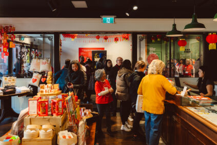 customers standing in line to check out at Foo Hung Curios