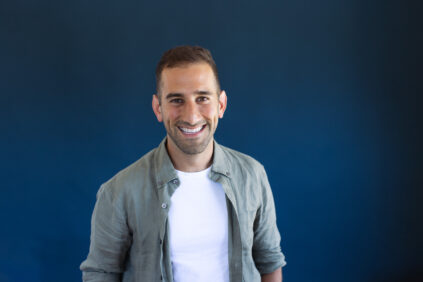 portrait of Bijan Vaez in front of a navy blue background