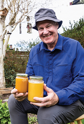 Stefan Fletcher holding two jars of honey