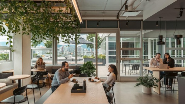 people sitting around a table chatting and working