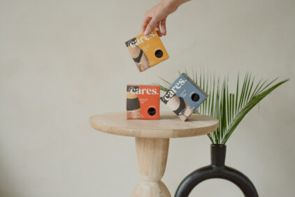 three boxes of Revol Cares products on a wooden table