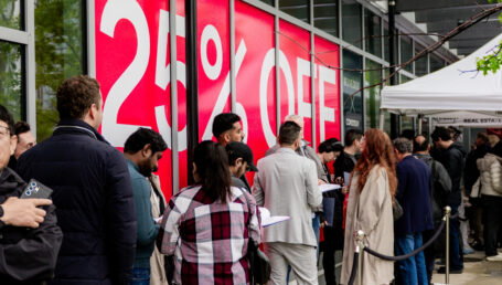 Buyers queued up in front of red flash condo sale sign